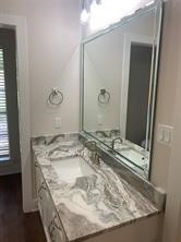 11792 Farrell Road Willis, TX 77378 - Photo 9 of 16 a bathroom with a granite countertop sink and a mirror