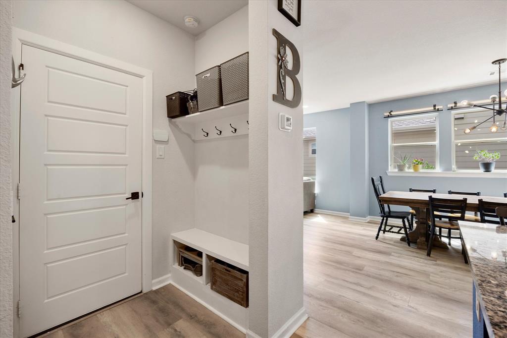 9224 Lamar Street Rowlett, TX 75089 - Photo 8 of 27 Entryway featuring a built-in bench with storage, upper shelving, and coat hooks