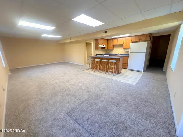 a view of kitchen with refrigerator and a sink