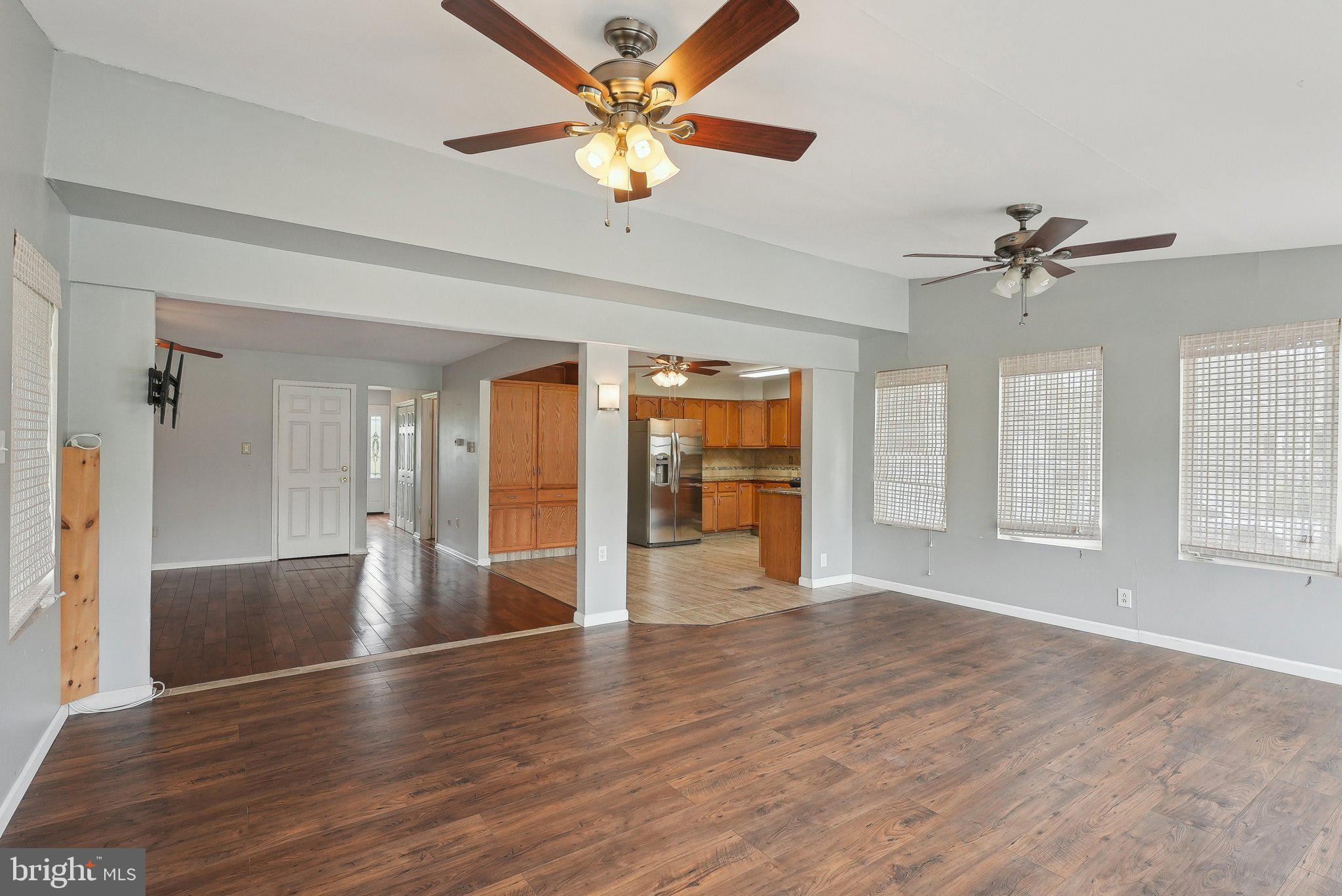317 Clems Run Mullica Hill, NJ 08062 - Photo 13 of 33 wooden floor in an empty room with a window