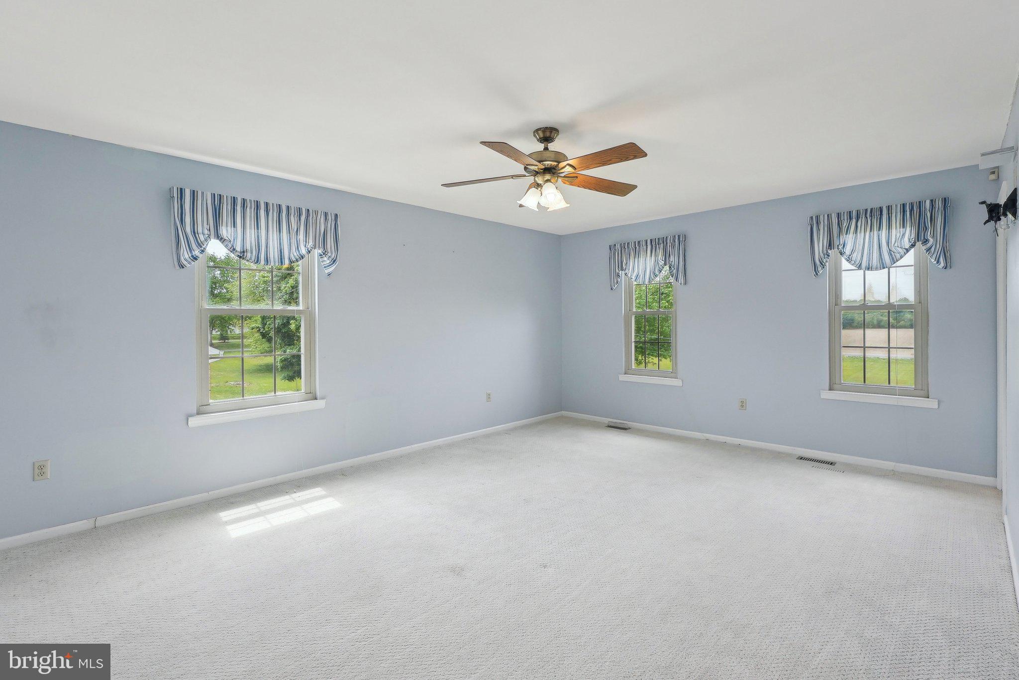 317 Clems Run Mullica Hill, NJ 08062 - Photo 17 of 33 an empty room with windows and ceiling fan