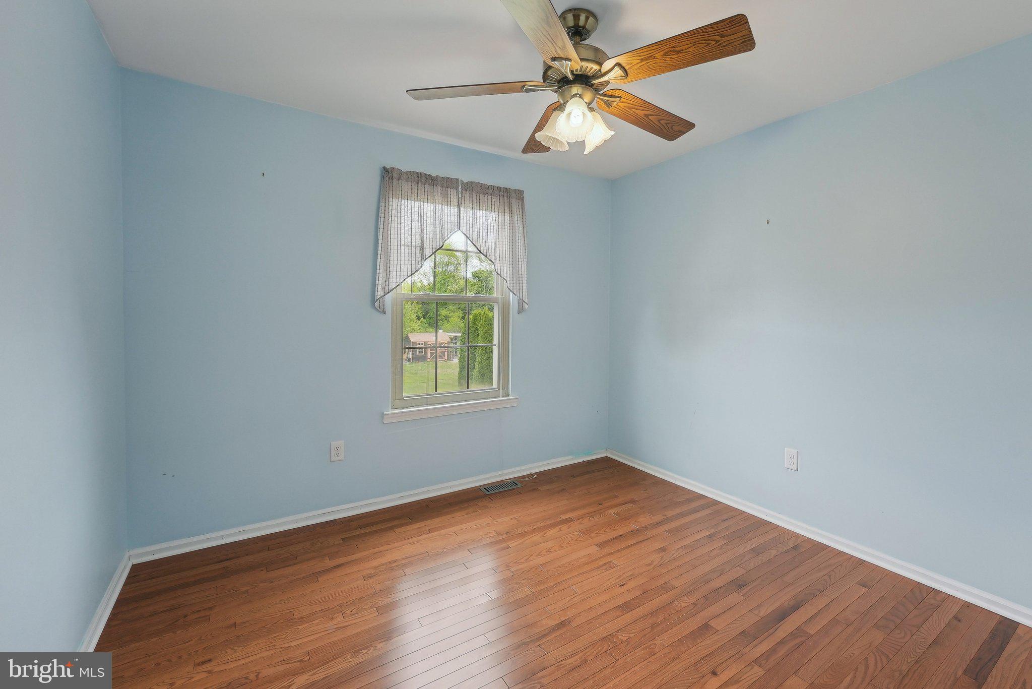 317 Clems Run Mullica Hill, NJ 08062 - Photo 23 of 33 an empty room with wooden floor fan and windows