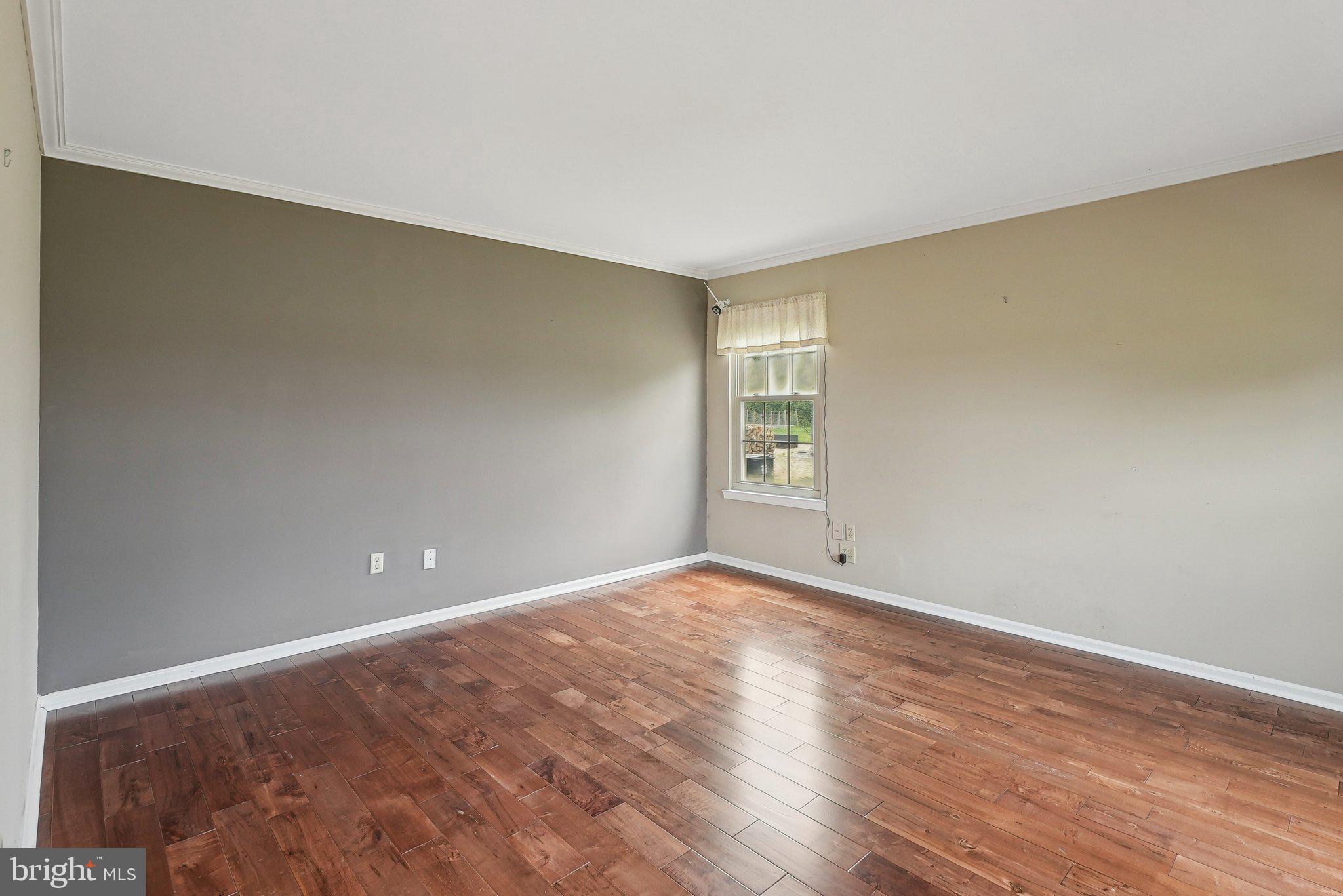 317 Clems Run Mullica Hill, NJ 08062 - Photo 4 of 33 a view of an empty room with wooden floor and a window
