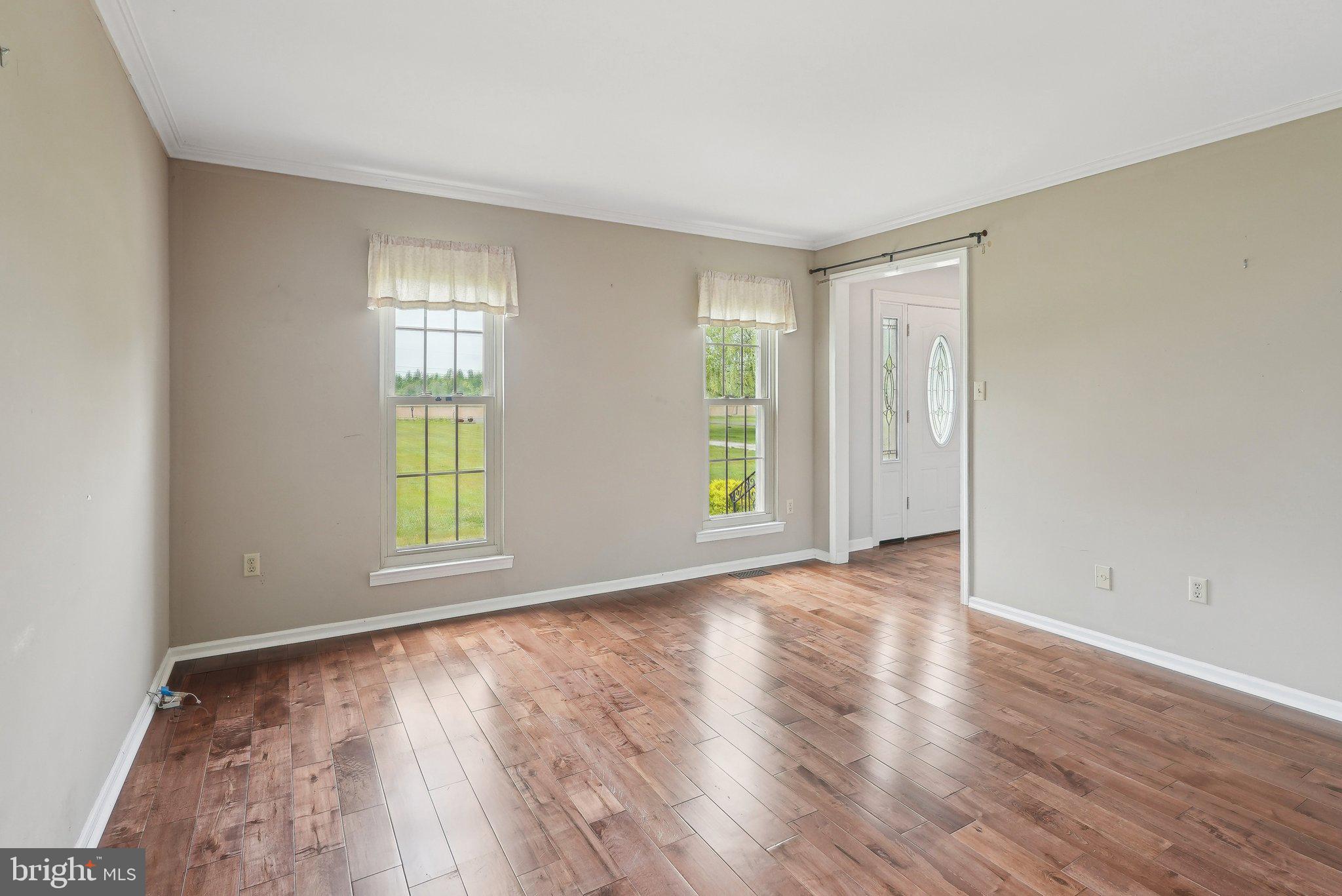317 Clems Run Mullica Hill, NJ 08062 - Photo 5 of 33 an empty room with wooden floor and windows