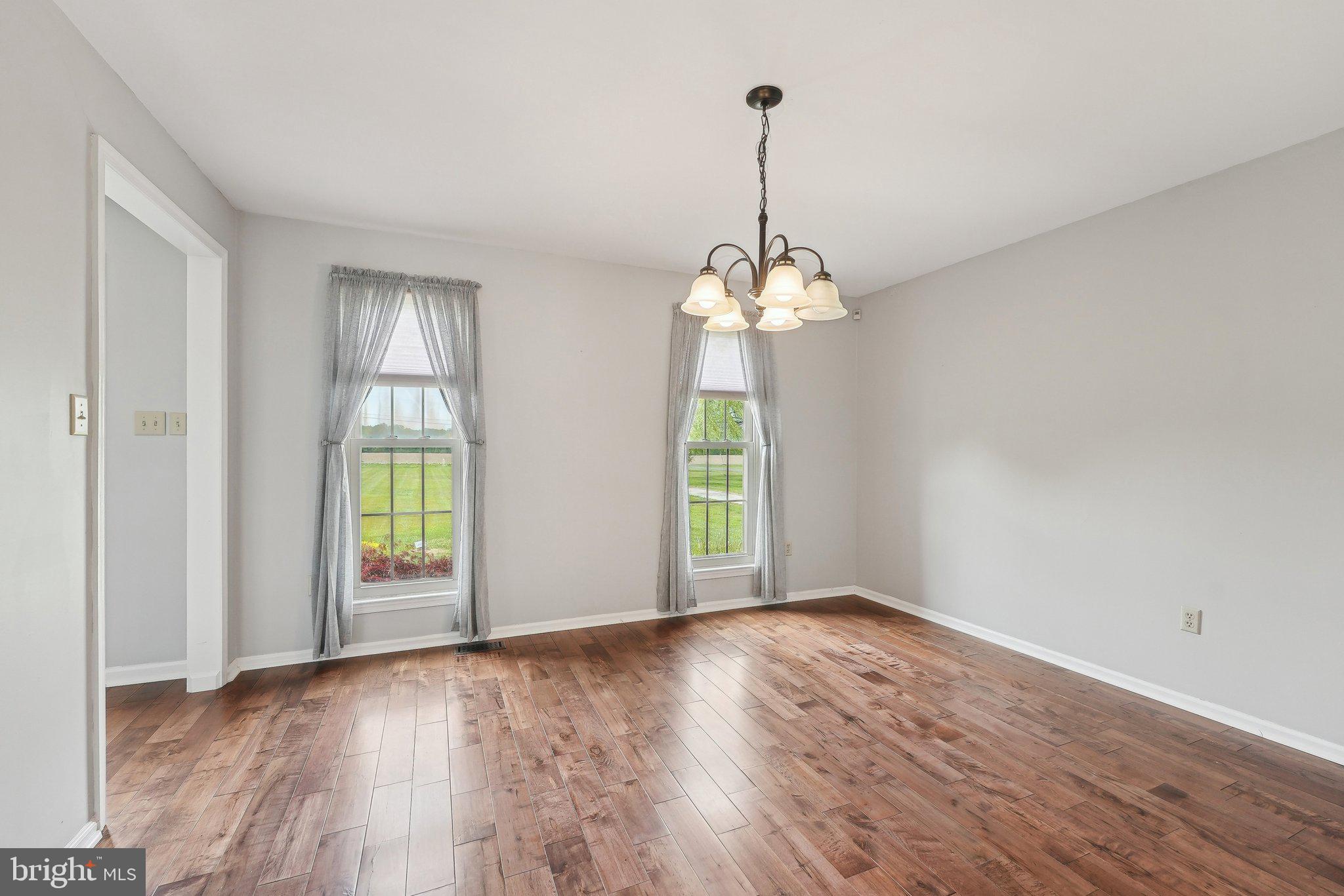 317 Clems Run Mullica Hill, NJ 08062 - Photo 7 of 33 a view of an empty room with window and wooden floor