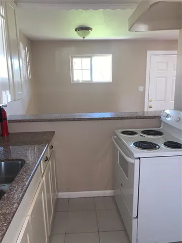 a kitchen that has a sink and a stove