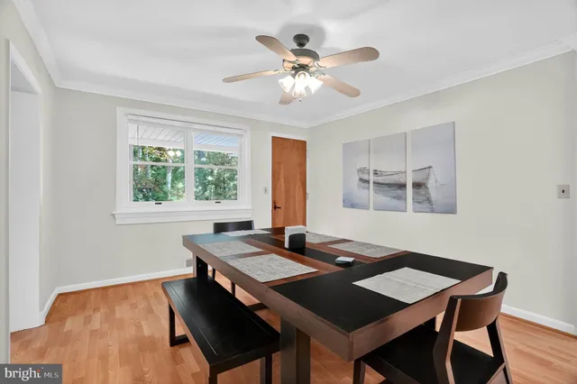 a view of a dining room with a table and chairs