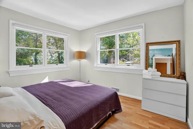 a bedroom with a bed and a large window
