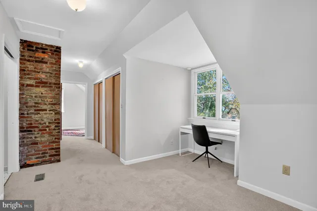 a view of room with window and furniture