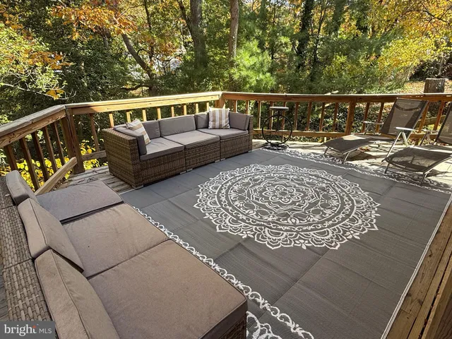 a balcony with wooden floors and outdoor seating