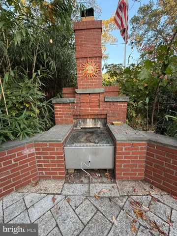 a view of a brick wall with plants and brick walls