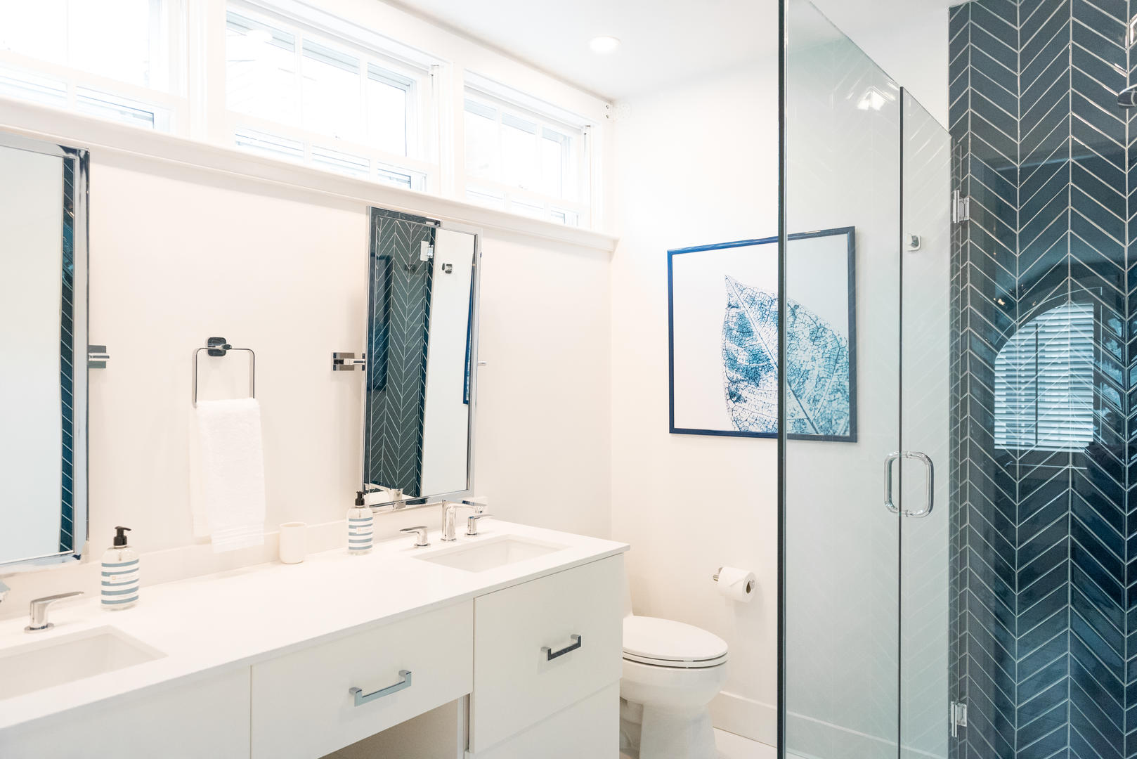 59 Orange Street Nantucket, MA 02554 - Photo 19 of 42 a bathroom with a sink a toilet and a large mirror