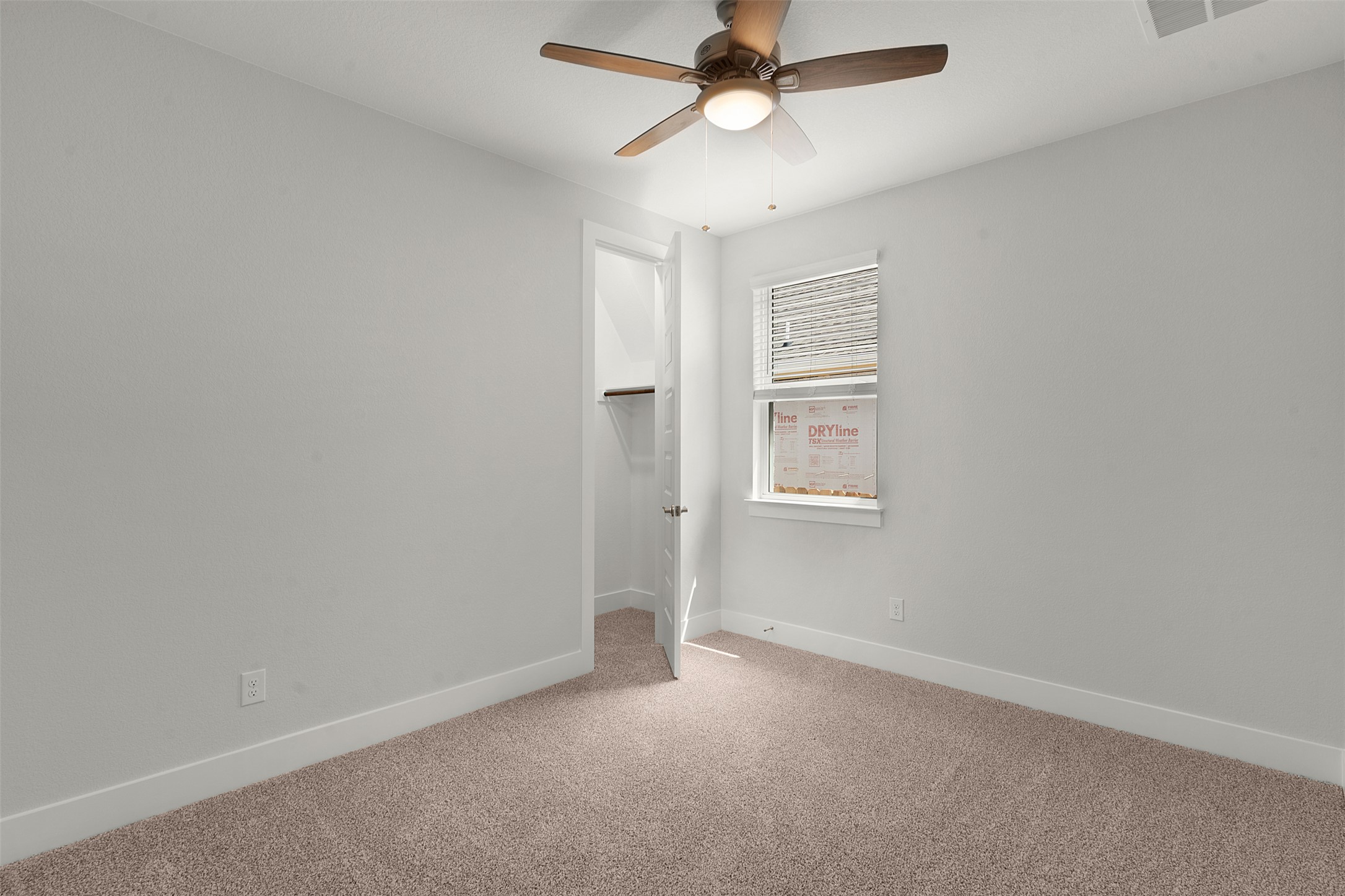 1129 Pansy Trail Georgetown, TX 78628 - Photo 8 of 29 Carpeted room with a ceiling fan light fixture, white walls, and white trim