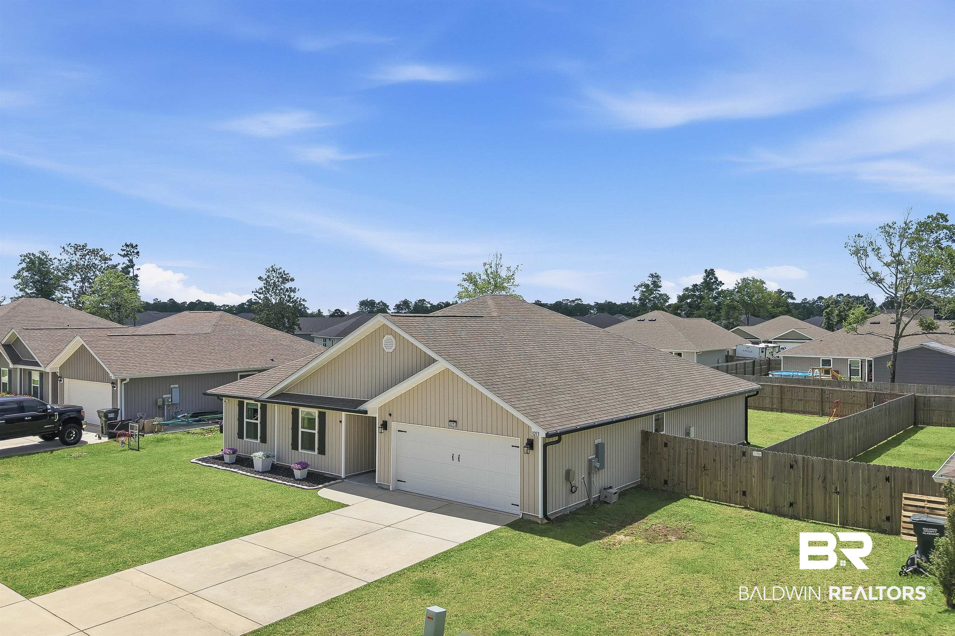 3213 Camino Real Loop Lillian, AL 36549 - Photo 10 of 61 Contemporary single-story residence featuring siding exterior and an attached two-car garage