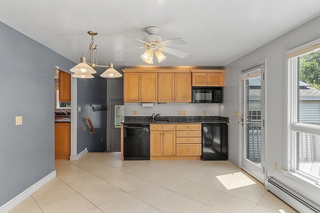 65 Charme Road Billerica, MA 01821 - Photo 8 of 31 a large kitchen with cabinets and stainless steel appliances