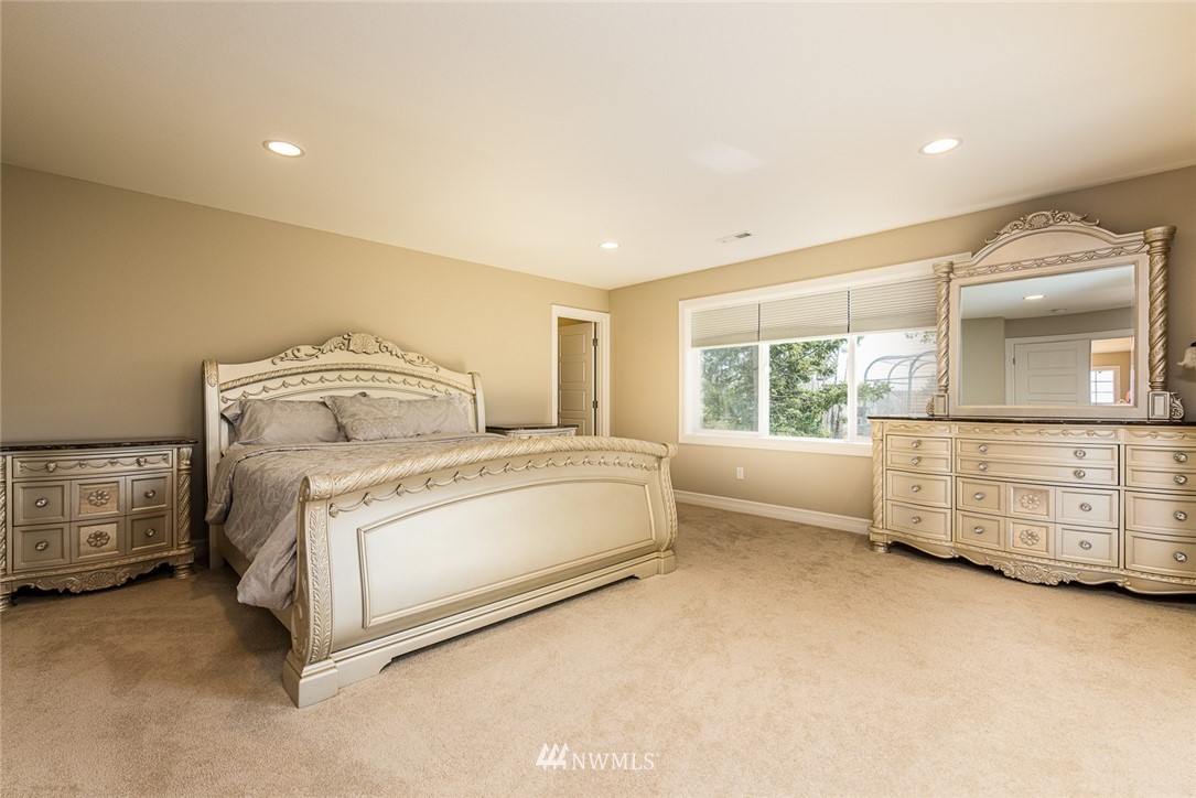 4407 Northeast 9th Street Renton, WA 98059 - Photo 8 of 13 a bed room with a bed and a mirror