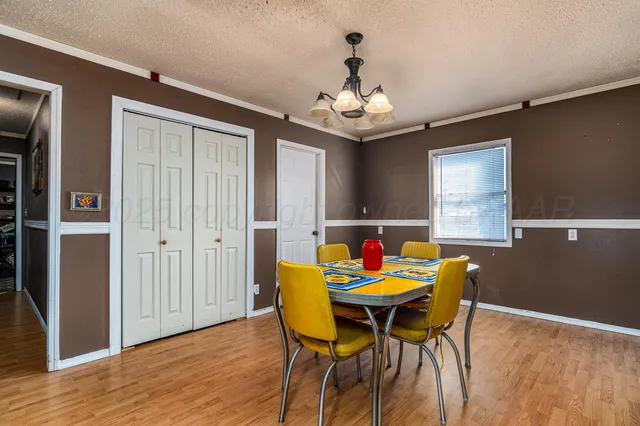 a view of a dining room with furniture wooden floor and chandelier