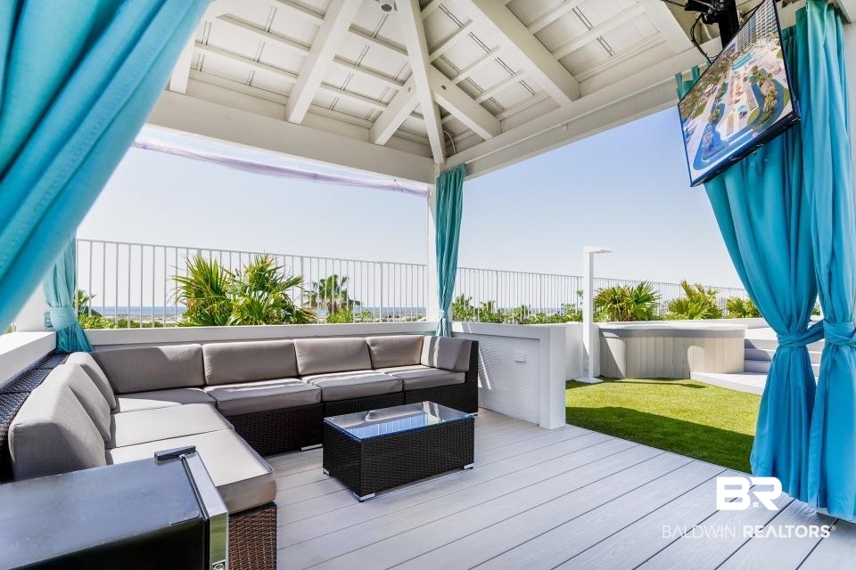 28107 Perdido Beach Boulevard, Unit DPH05 Orange Beach, AL 36561 - Photo 31 of 43 Wooden deck with outdoor furniture and a lawn