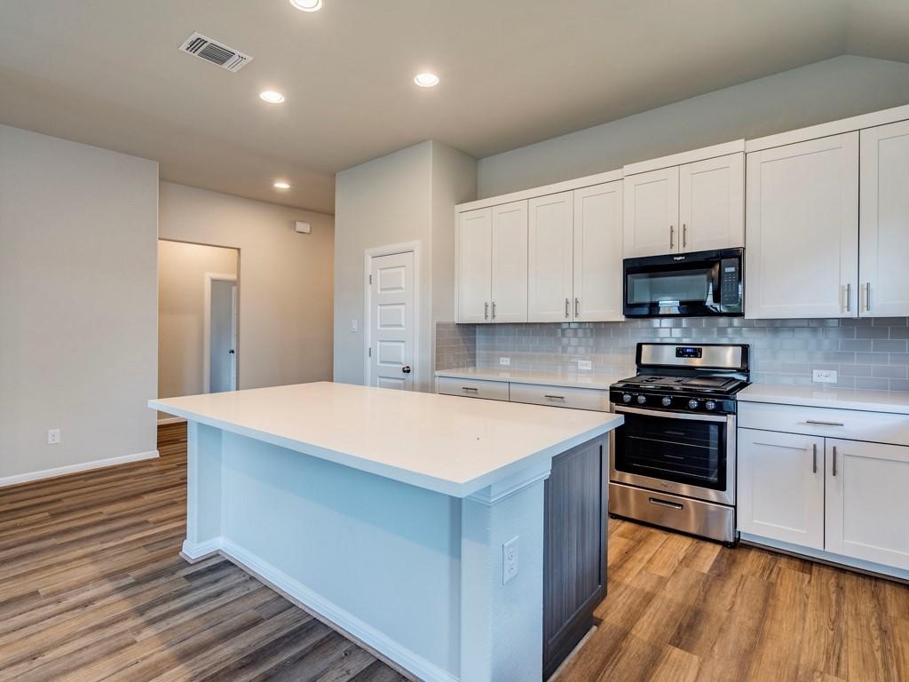 270 Rimrock Court Bastrop, TX 78602 - Photo 15 of 34 Inside, the open-concept kitchen is the heart of the home, featuring stainless steel appliances, a generous island, and plenty of space to gather, cook, and connect.