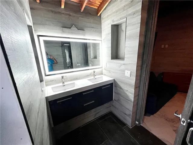 a bathroom with a sink and a mirror