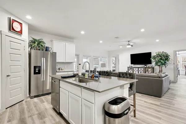 a kitchen with kitchen island a sink and refrigerator
