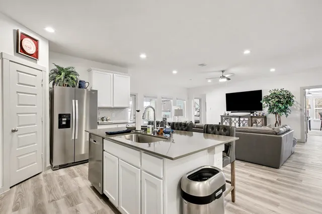 a kitchen with kitchen island a sink and refrigerator
