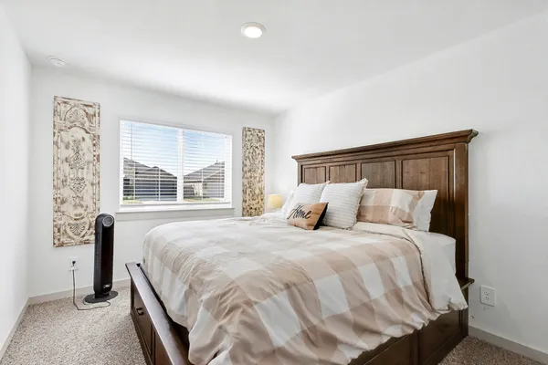 a bedroom with a bed and a window