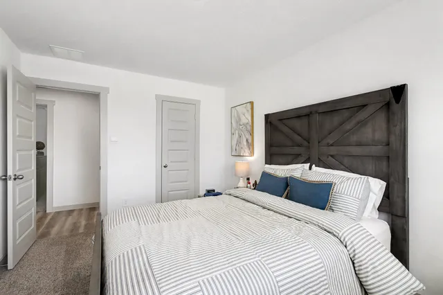 a bedroom with a bed and a window