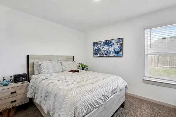 a bedroom with bed and window