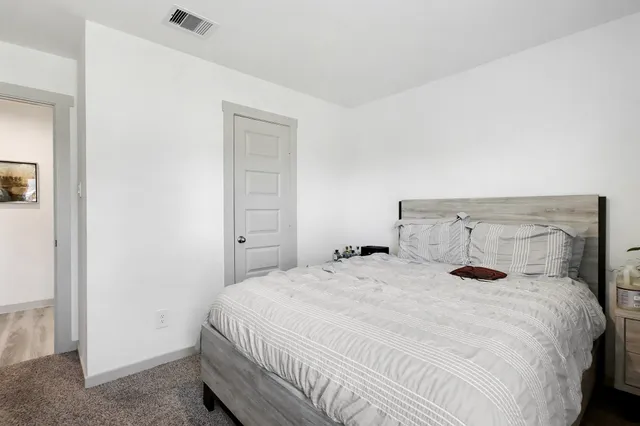 a bedroom with a bed and window