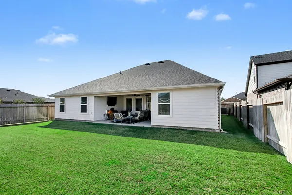 a front view of a house with yard and tree s