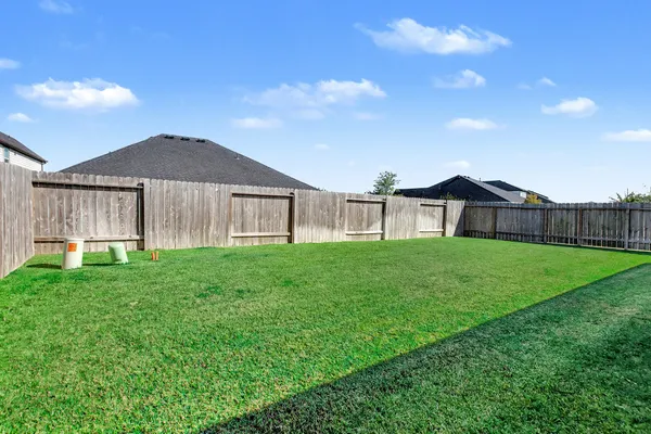 a view of an house with backyard space and balcony