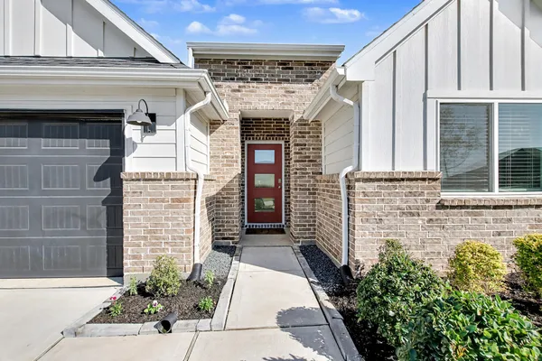 a front view of a house with a garden