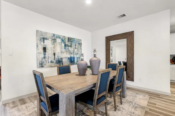 a dining room with furniture and window