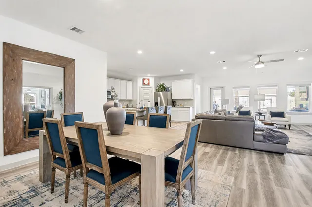 a large kitchen with a table and chairs
