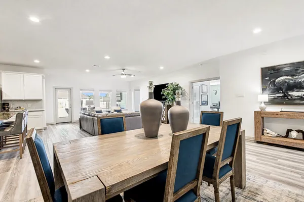 a dining room with furniture and wooden floor