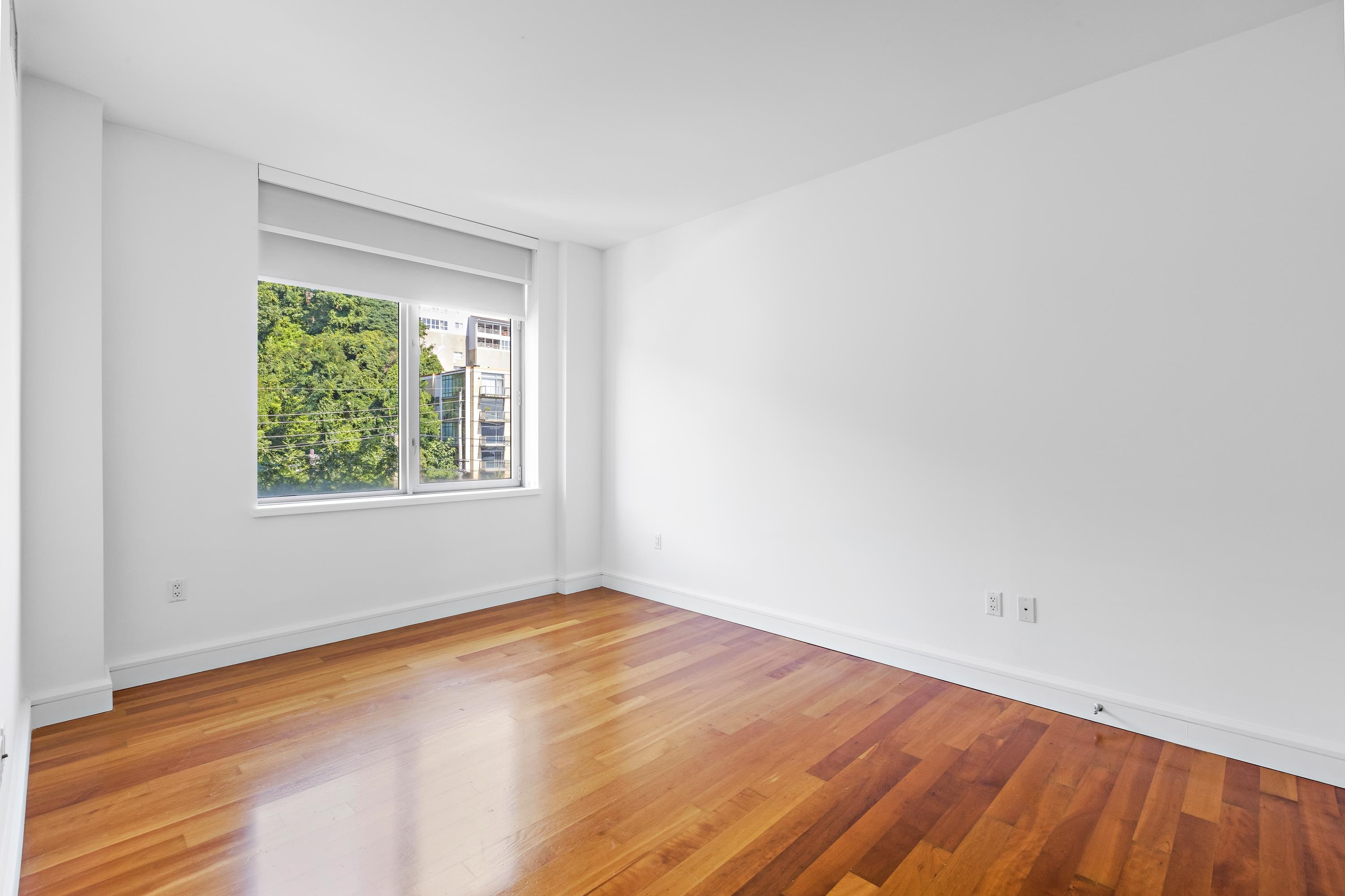 8100 River Road, Unit 510 North Bergen, NJ 07047 - Photo 20 of 25 an empty room with wooden floor and windows