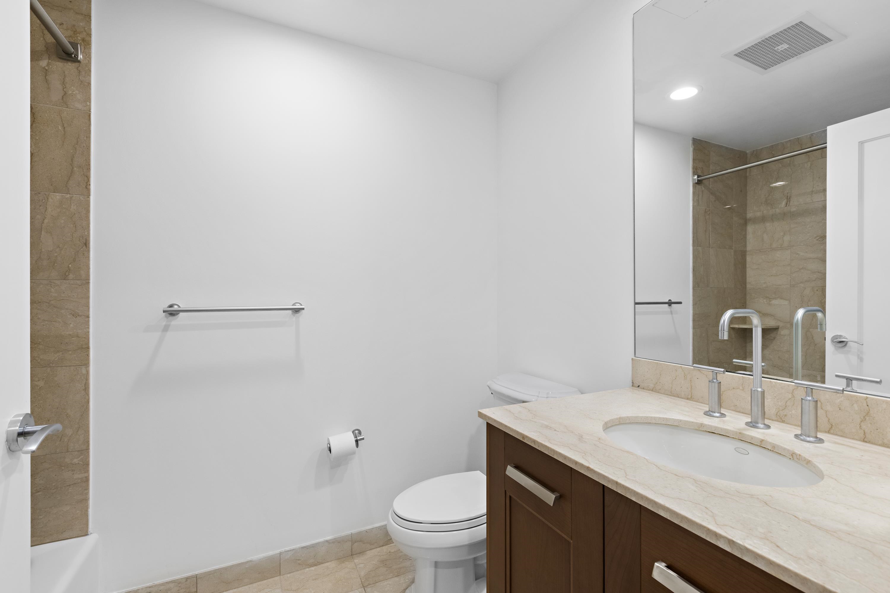 8100 River Road, Unit 510 North Bergen, NJ 07047 - Photo 22 of 25 a bathroom with a granite countertop sink a toilet and a mirror