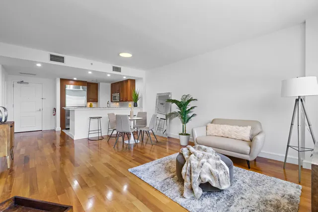 a living room with furniture and wooden floor