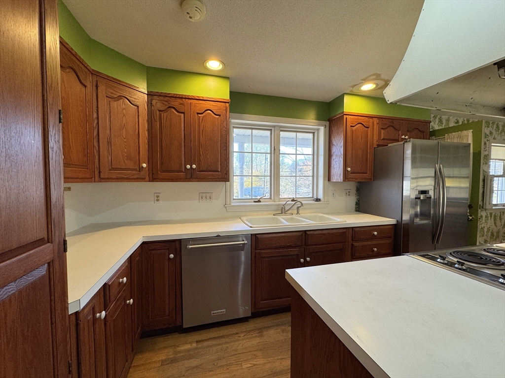 696 Bernardston Road Greenfield, MA 01301 - Photo 14 of 42 a kitchen with a sink and wooden cabinets