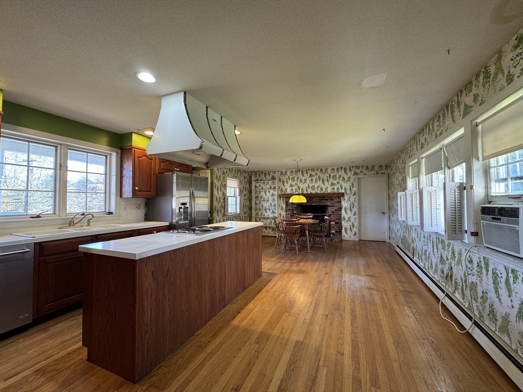 696 Bernardston Road Greenfield, MA 01301 - Photo 15 of 42 a kitchen with wooden floors and wooden cabinets