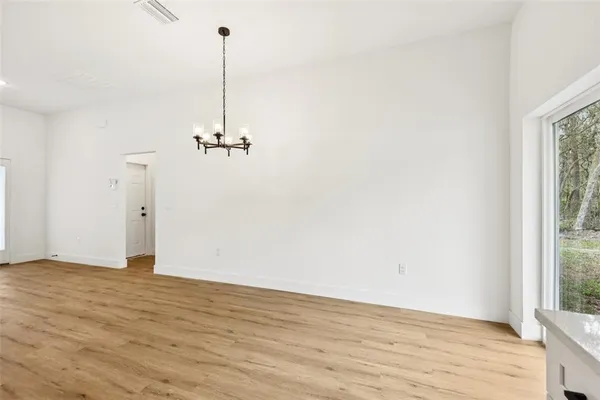 a kitchen with stainless steel appliances a stove top oven and a refrigerator