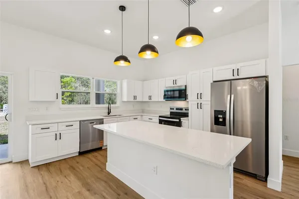 a kitchen with a sink stove and refrigerator