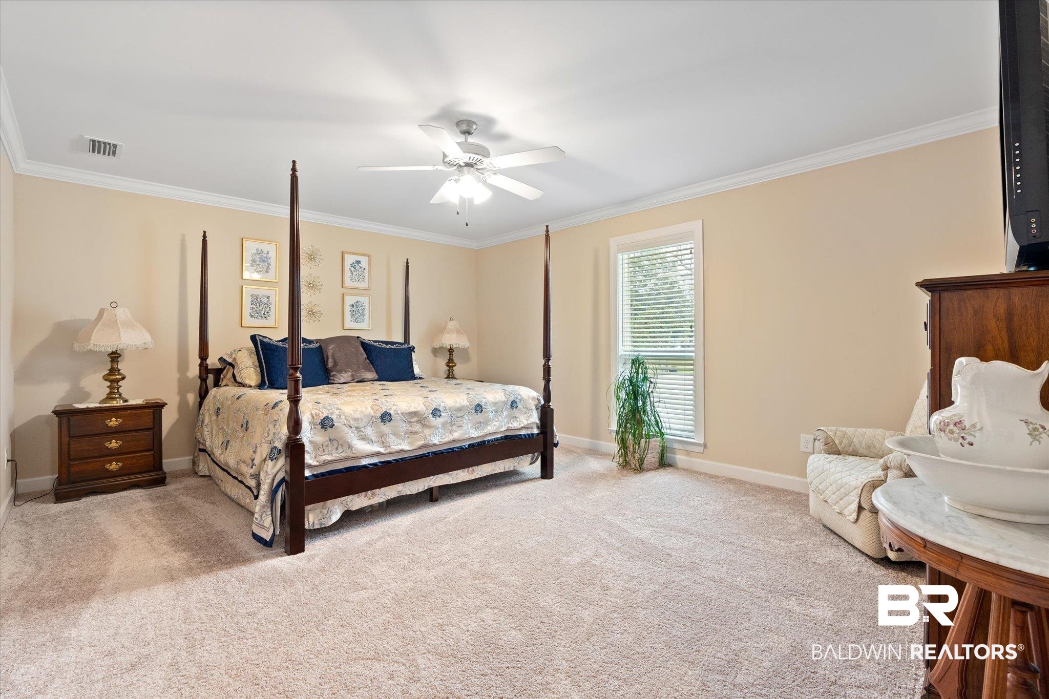734 West Section Avenue Foley, AL 36535 - Photo 14 of 50 Bedroom with baseboards, carpet floors, visible vents, and ornamental molding