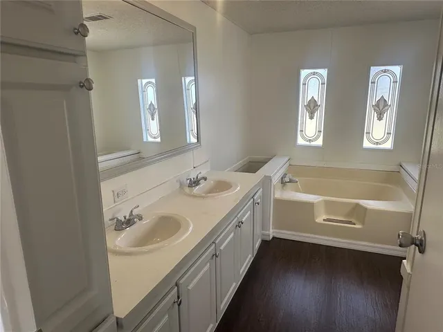 a white toilet and tub sitting next to a bathroom sink