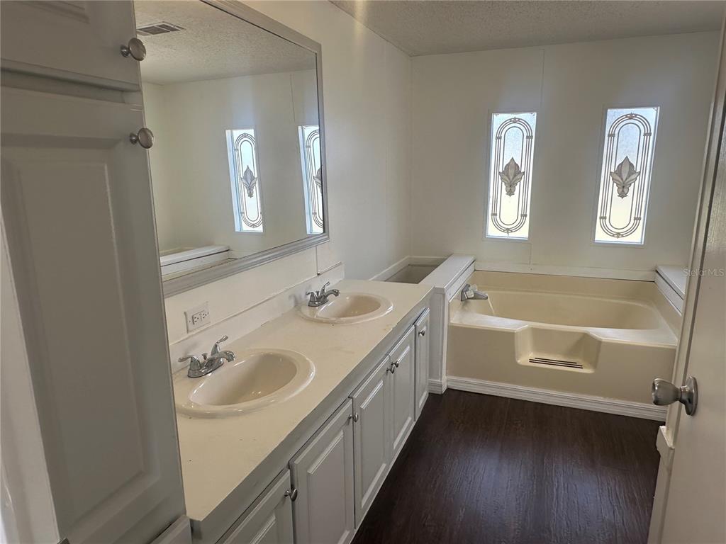 447 Tindel Camp Road Lake Wales, FL 33898 - Photo 12 of 15 a bathroom with a double vanity sink a mirror and a bathtub