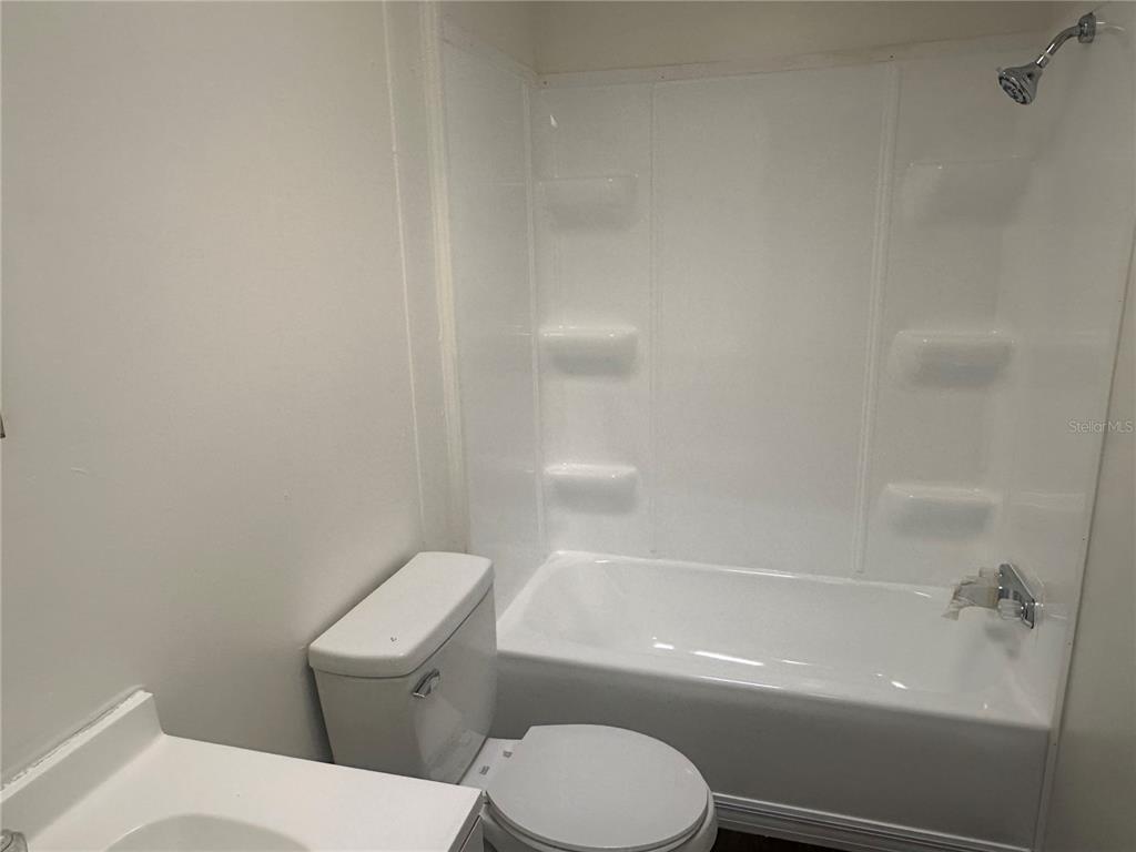 447 Tindel Camp Road Lake Wales, FL 33898 - Photo 13 of 15 a white toilet and tub sitting next to a bathroom sink