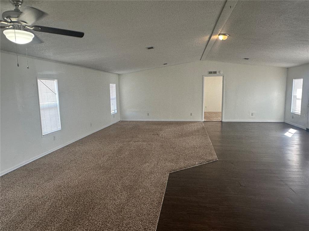 447 Tindel Camp Road Lake Wales, FL 33898 - Photo 6 of 15 an empty room with wooden floor and windows