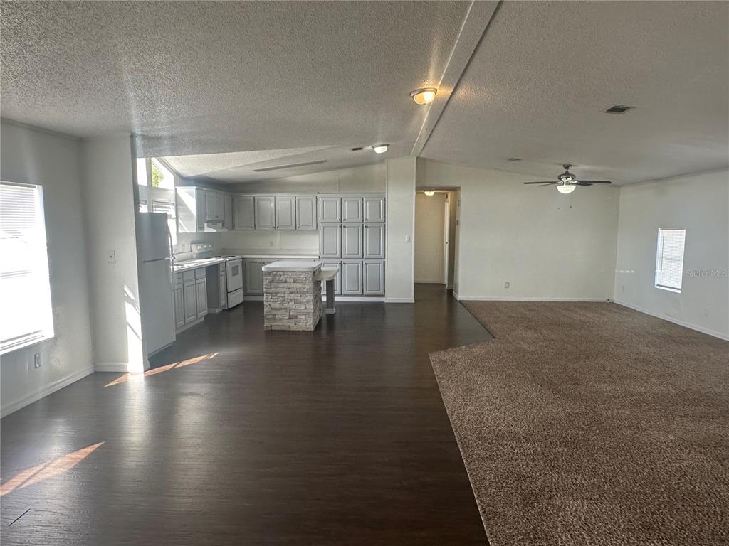 447 Tindel Camp Road Lake Wales, FL 33898 - Photo 7 of 15 an empty room with wooden floor and windows