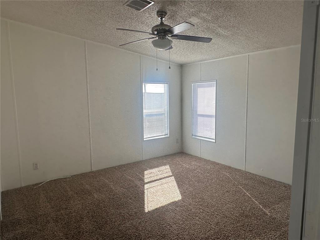 447 Tindel Camp Road Lake Wales, FL 33898 - Photo 10 of 15 an empty room with windows and fan